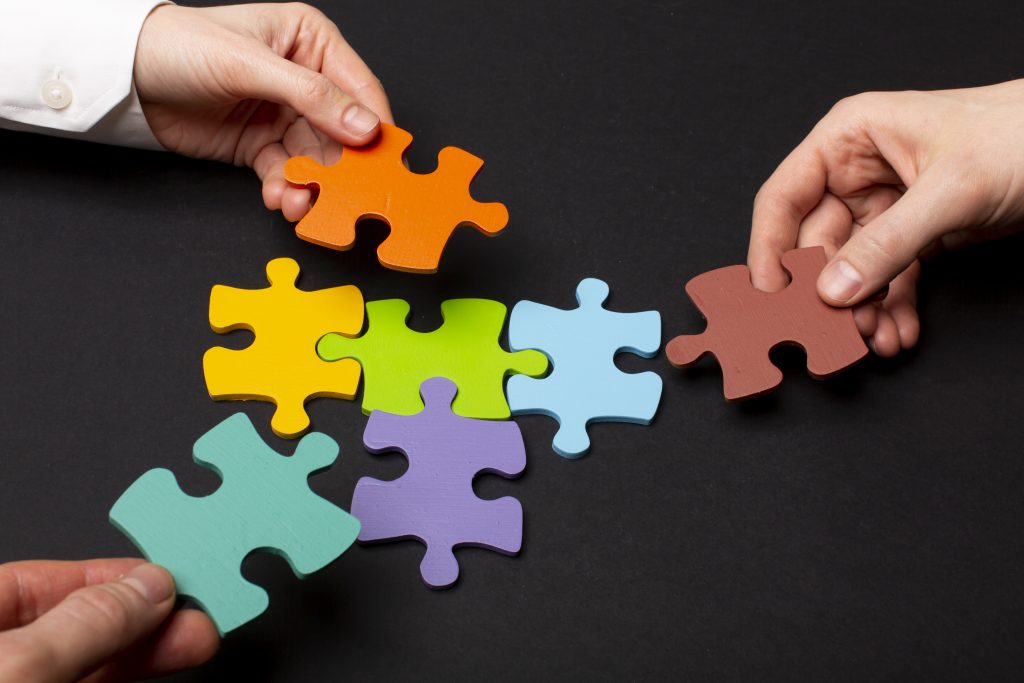 still life business roles with various puzzle pieces